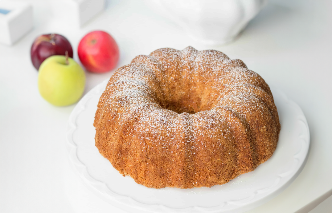 Freshly baked Apple Cider Cake on a fall-themed table setting.