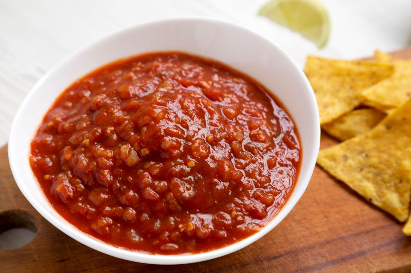 Assortment of chili peppers used to adjust salsa spiciness levels.